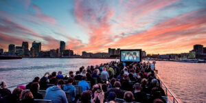 people watching movies on the river on a city cruises boat