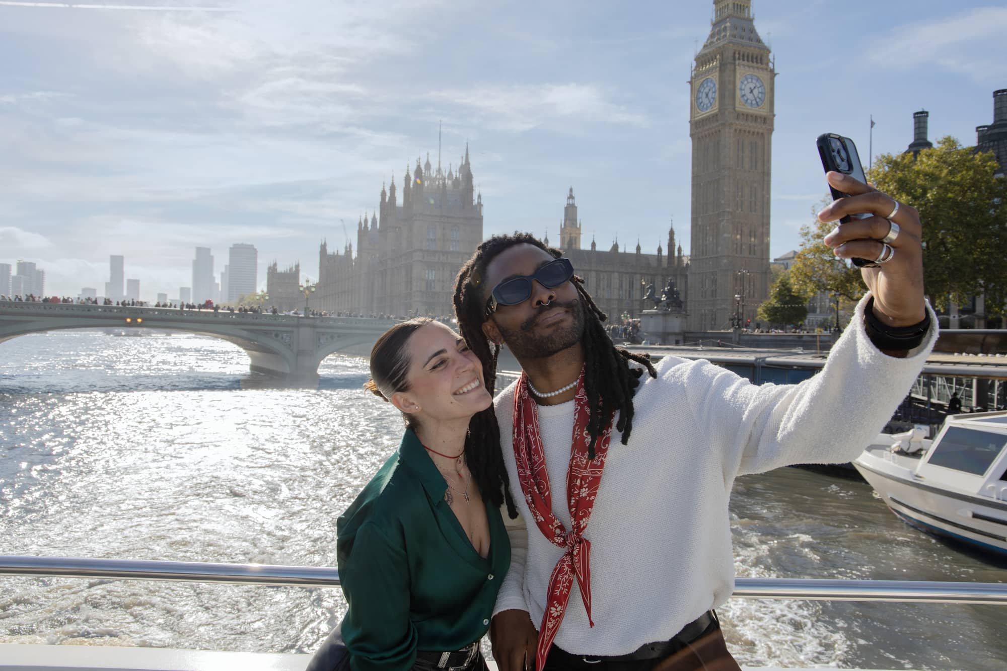 Two people taking a selfie with Elizabeth Tower in backgtound